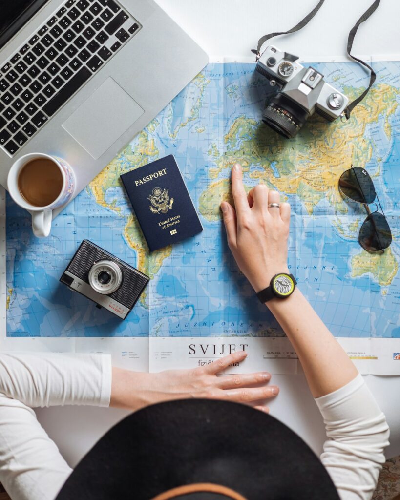 Planning a trip with a world map, passport and camera